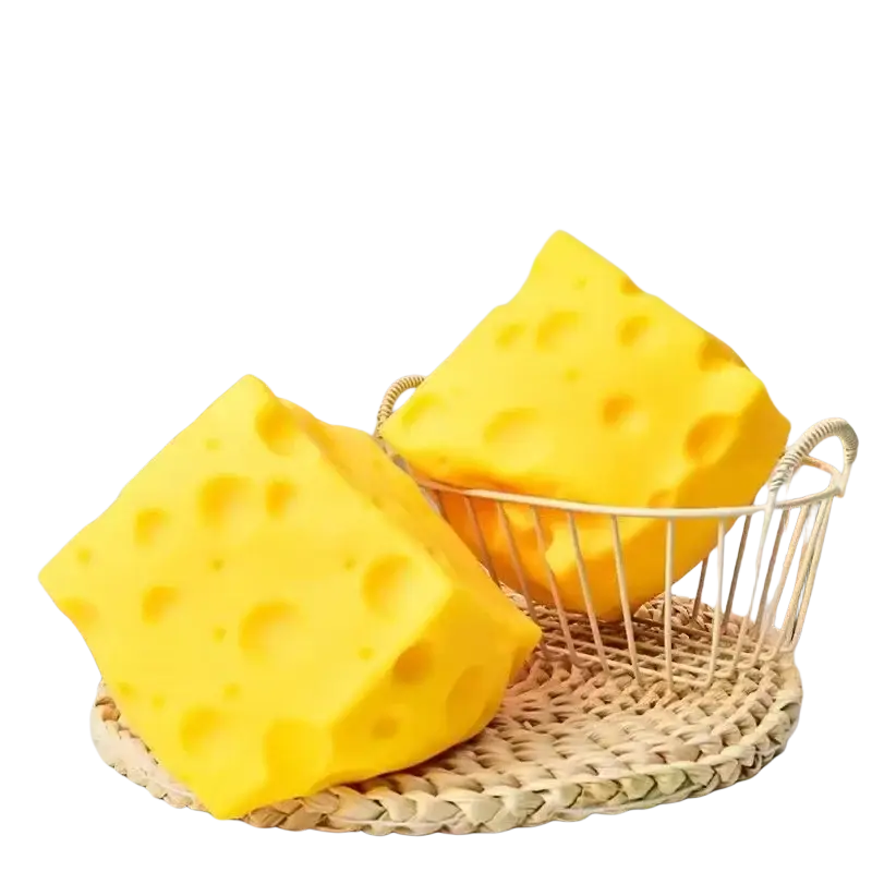 Yellow cheese squishy stress relief toy made of bright yellow cube-shaped sponge with swiss cheese style holes