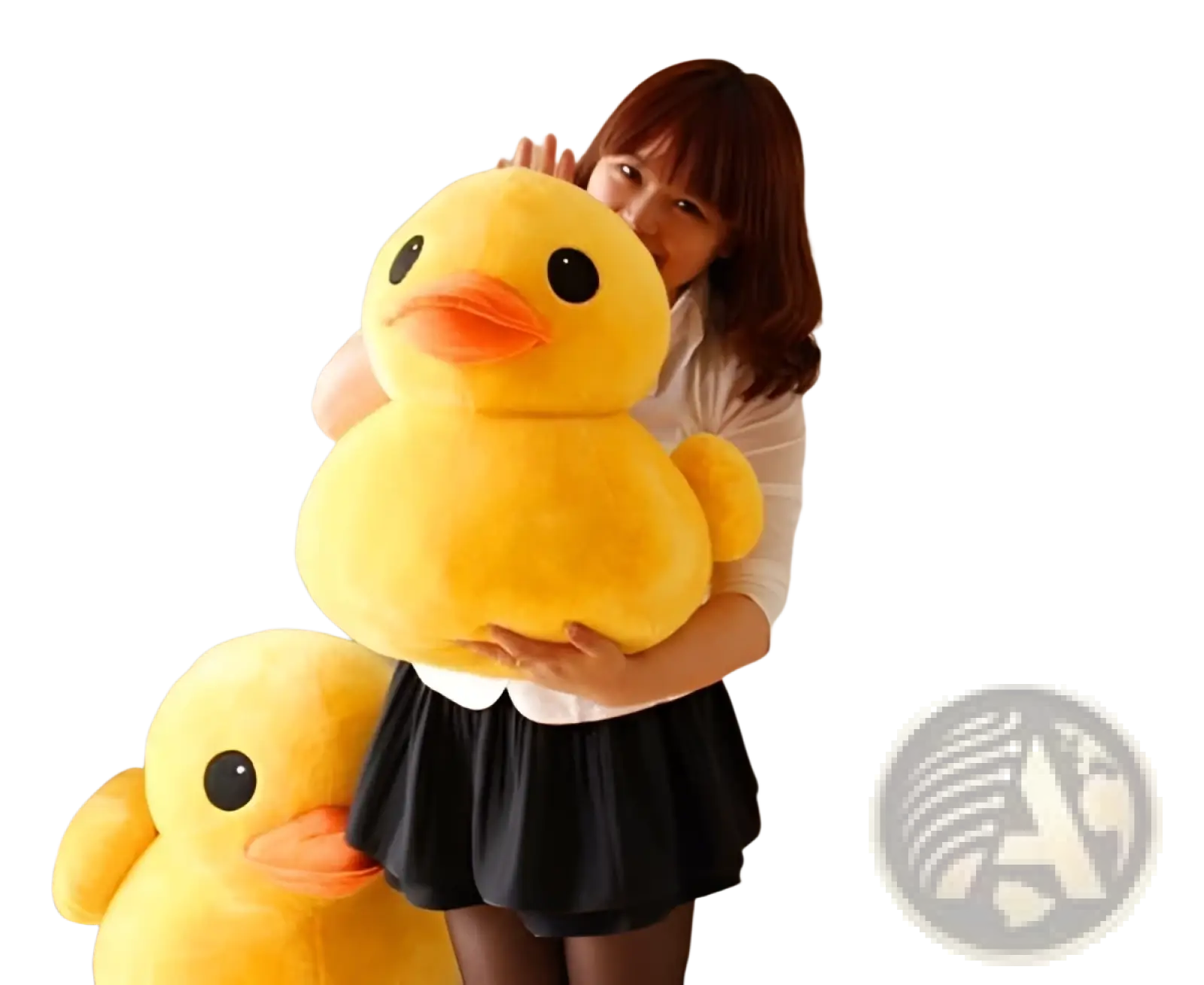 A plush yellow duck soft stuffed animal with black eyes and orange beak held in a cozy room setting