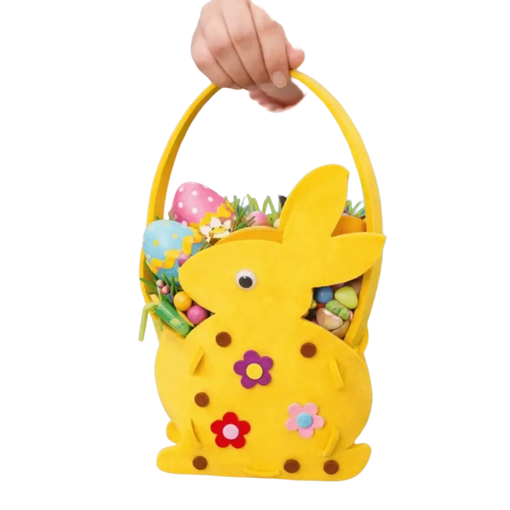 A cheerful yellow felt Easter bunny basket gift bag adorned with colorful fabric flowers filled with decorated eggs and greenery
