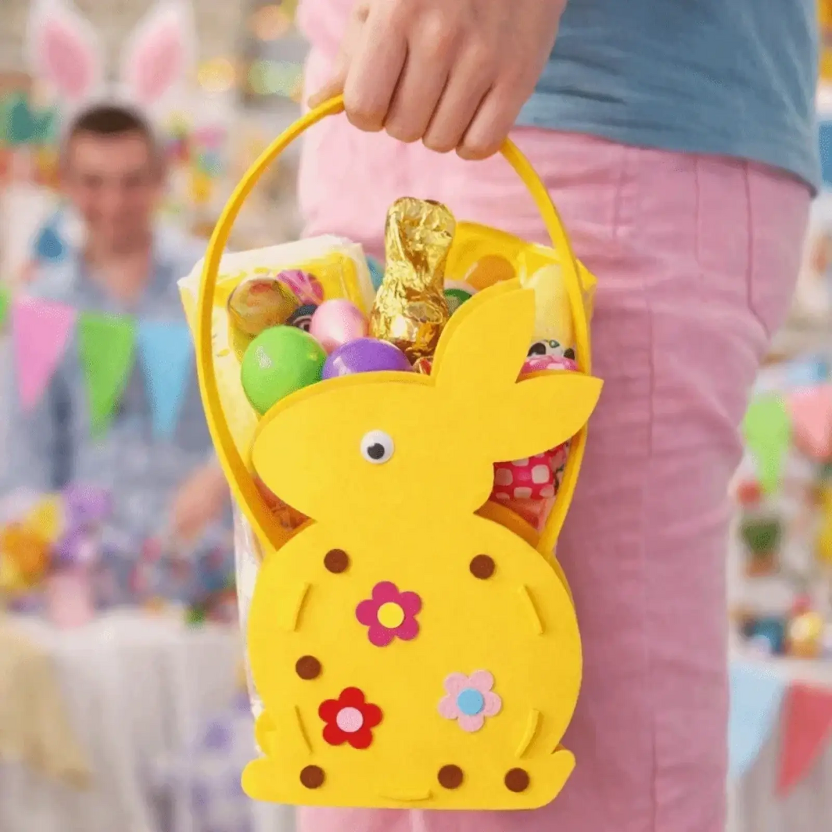 Yellow felt easter bunny basket gift bag with colorful flower decals and brown dot accents in bunny shape