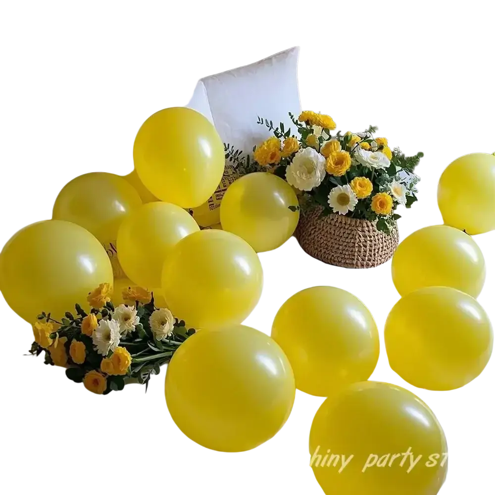 A cluster of bright yellow latex balloons arranged as a party arch decor with a woven basket and flowers