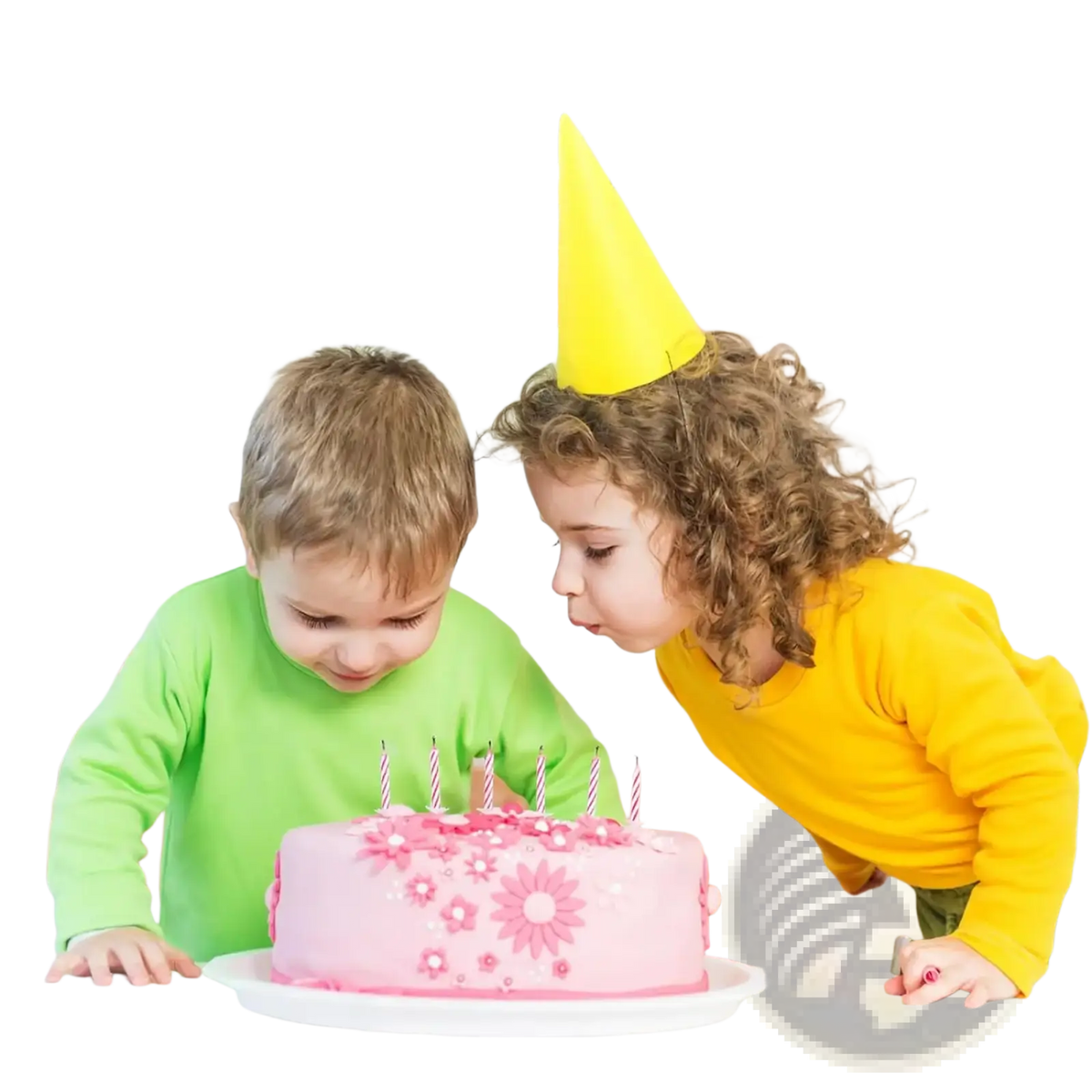 Pink birthday cake with pink floral decorations and white candles complemented by yellow party decorations paper fans and pom poms