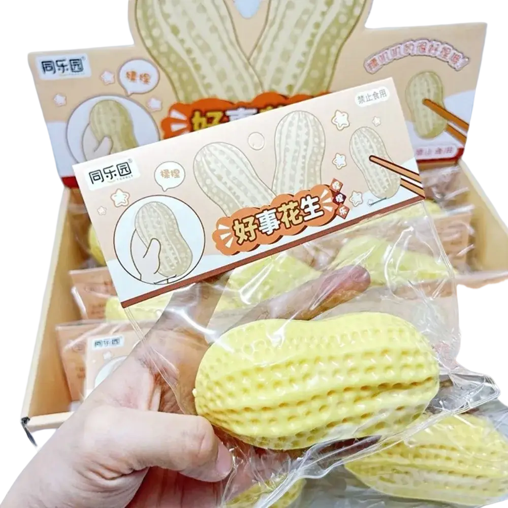 Yellow textured peanut-shaped stress relief squishy toy in clear plastic bag with chinese branding visible