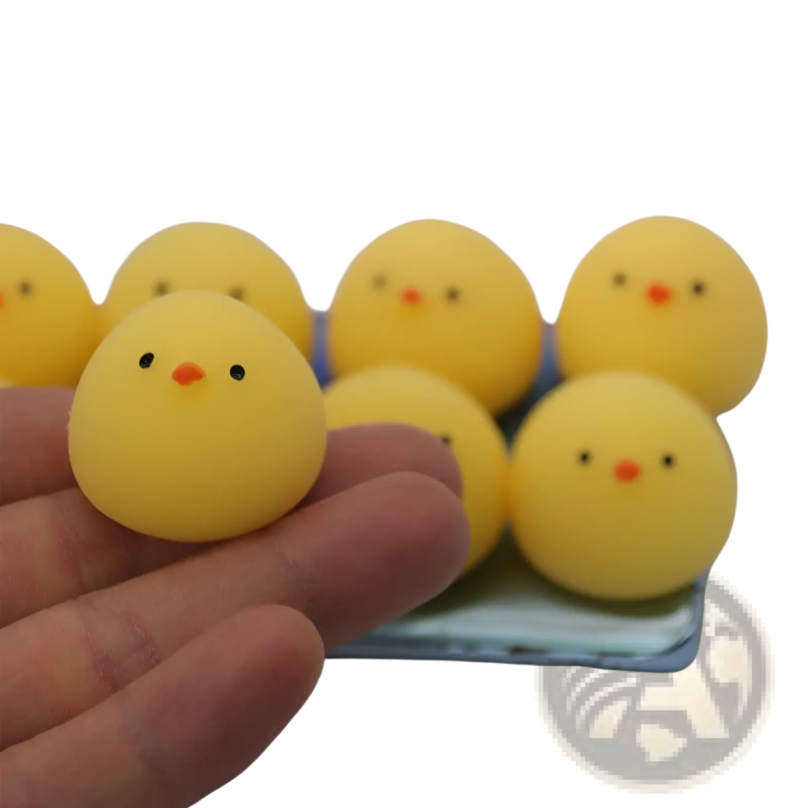Yellow rubber chicken stress ball squeezing toy with black dot eyes and orange beak made of soft material