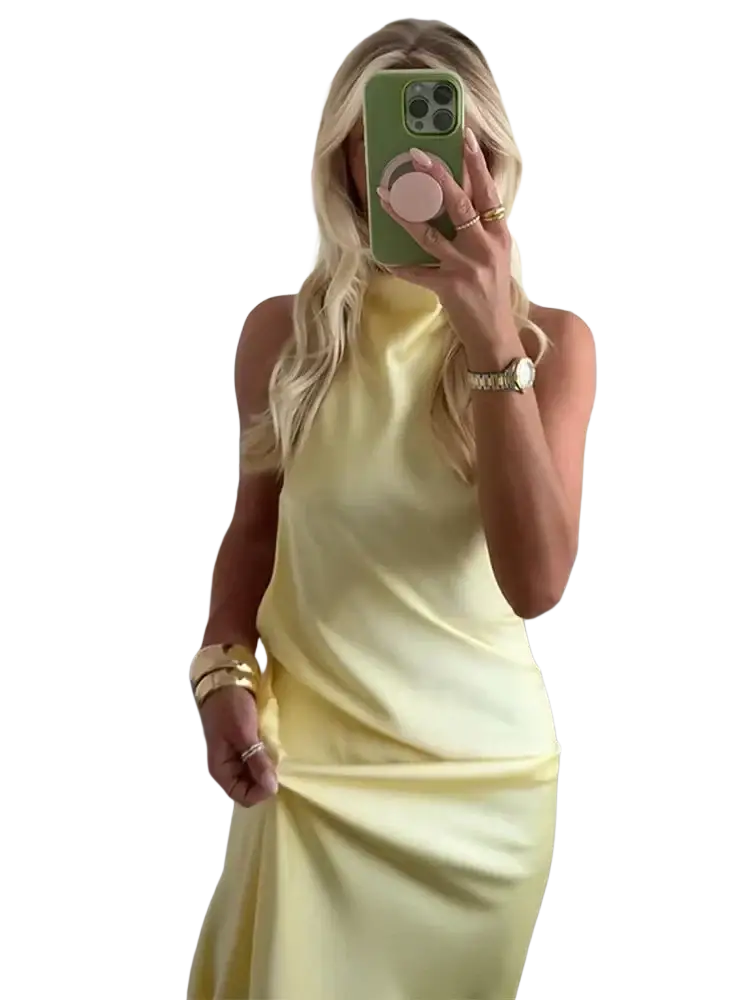A sleek pale yellow satin halter neck evening maxi dress with a flowing silhouette
