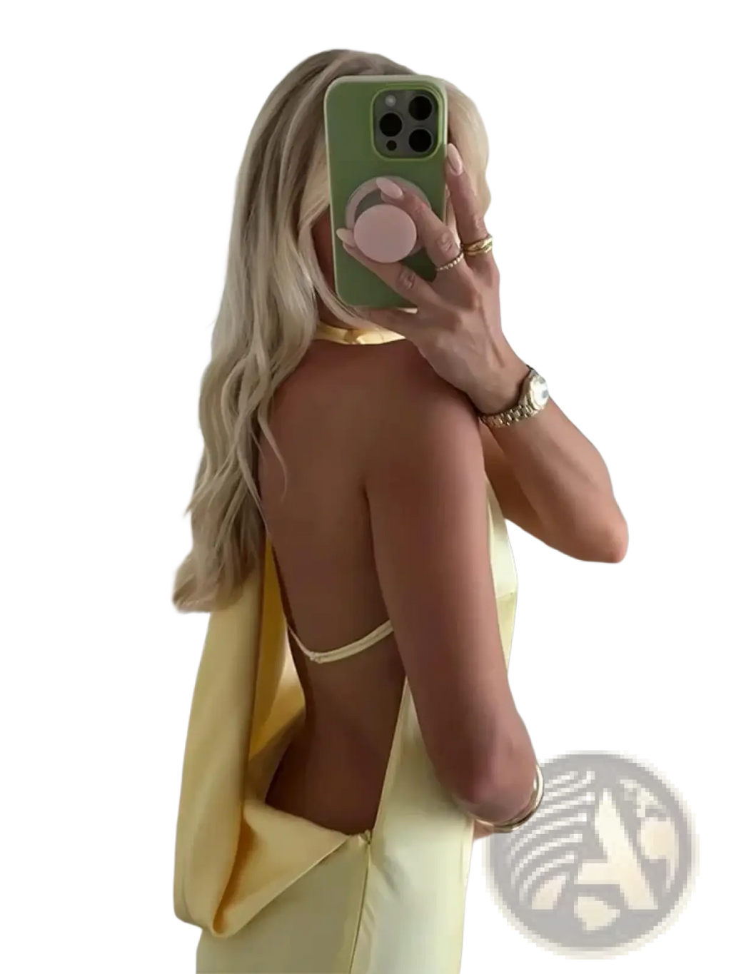 A woman wearing the back side of a yellow satin halter evening maxi dress with delicate gold-toned straps