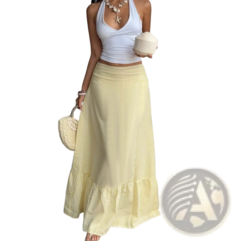 A flowing pale yellow maxi skirt with subtle vertical ribbed texture and layered ruffle hem for elegant wear