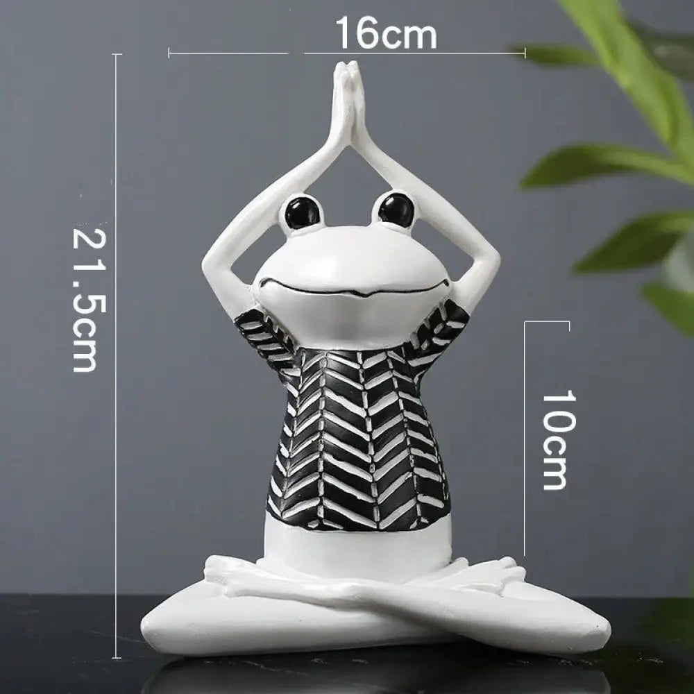 White ceramic frog figurine in yoga pose wearing black and white chevron patterned top for zen meditation