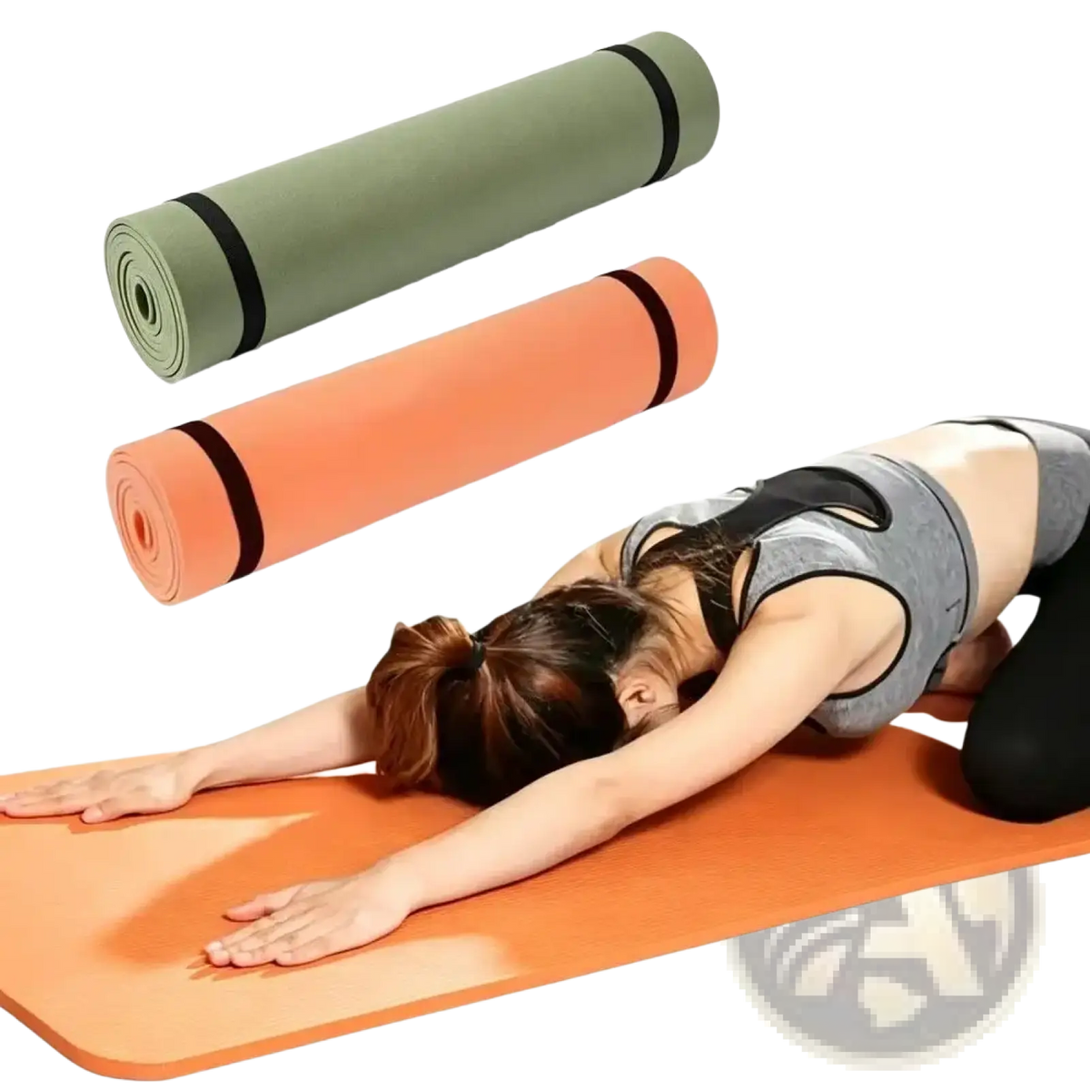 Orange non-slip eva yoga mat with black straps used by a woman in gray workout attire performing a stretch