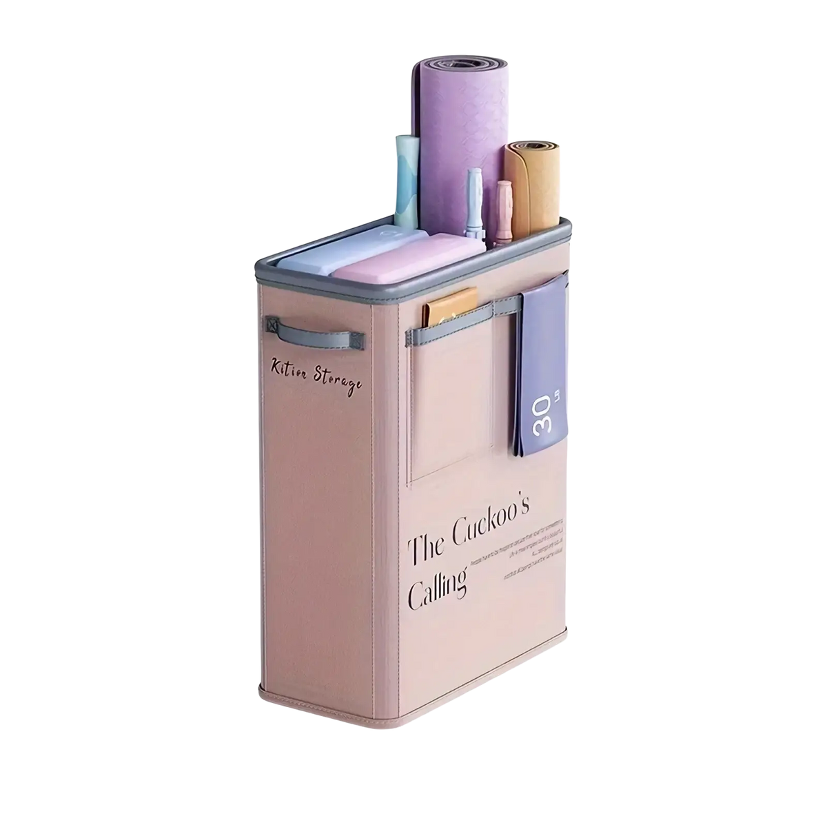 A blush pink rectangular yoga mat storage basket with gray trim and handles featuring the text the cuckoos calling