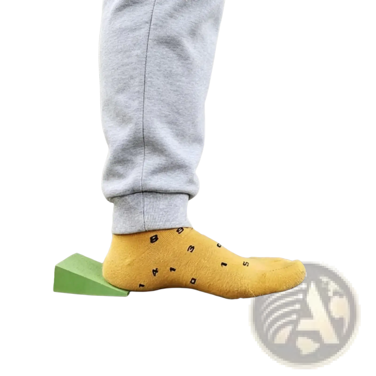 Yellow sock with black lettering worn on a foot paired with a yoga wedge block for stretching and squats use