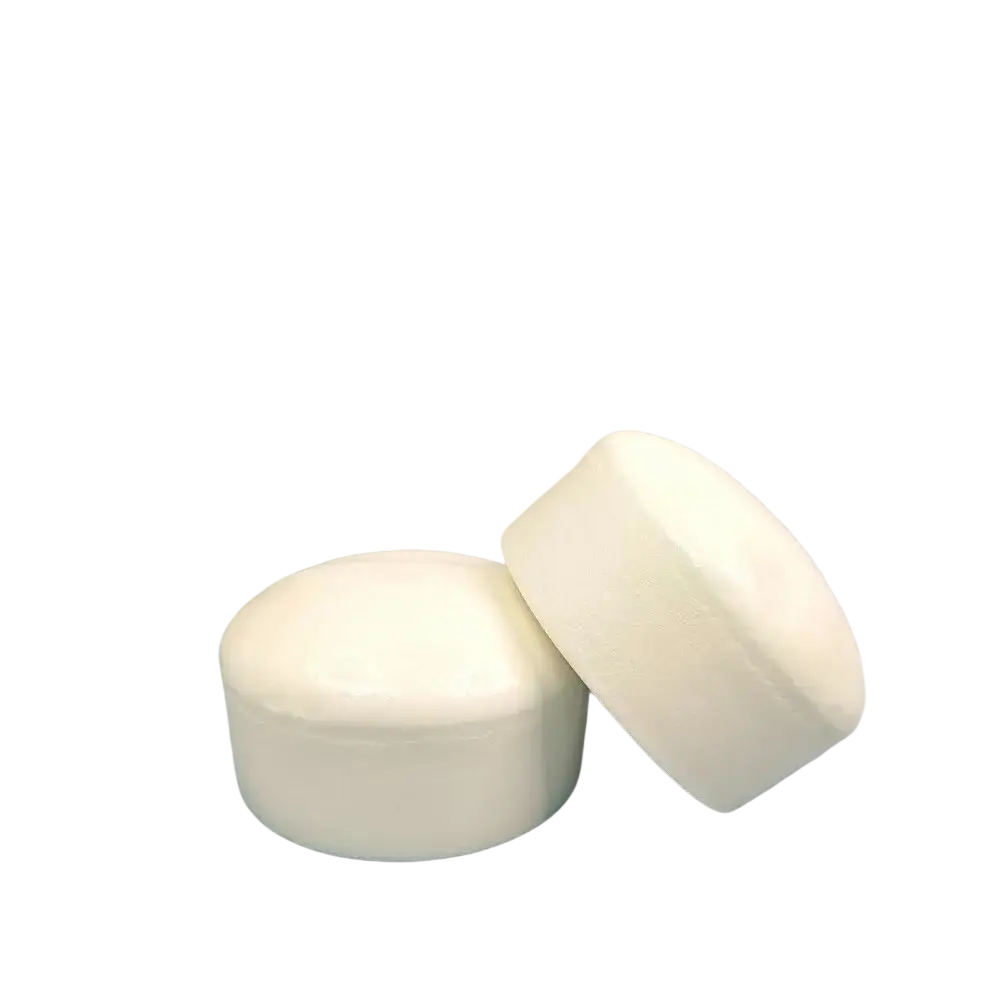 White cylindrical yogurt cake stress relief squishy toy candle holders one upright one tilted on its side