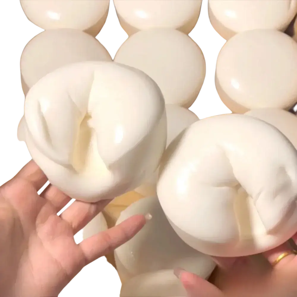 White glossy round yogurt cake stress relief squishy toy with irregular surface and visible internal texture