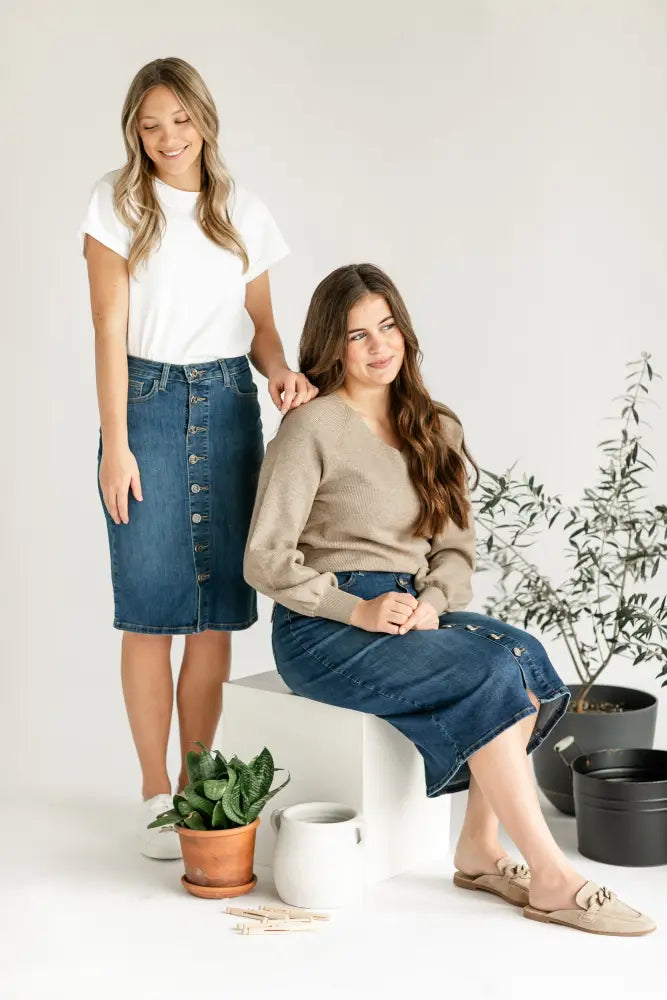 Blue denim midi skirt with front buttons and side kick pleat detail in a casual versatile design