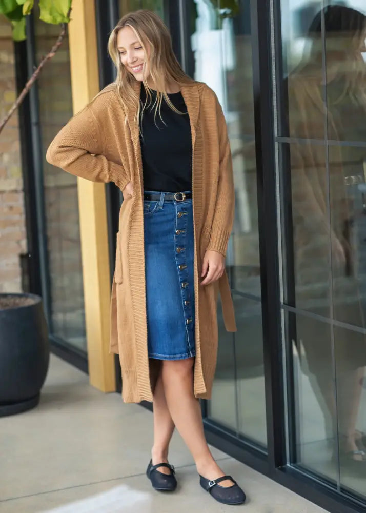 Tan knitted cardigan with long sleeves and front pocket paired with zana front button denim midi skirt with kick pleat