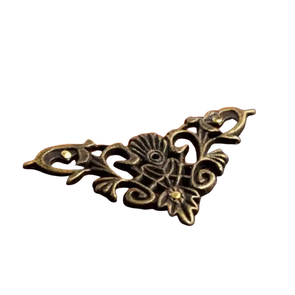 Antique brass floral zinc alloy corner protector on a richly grained wooden box for edge protection