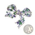 A sparkling silver zircon bow brooch with oval-cut purple and green gemstones luxury French design jewelry