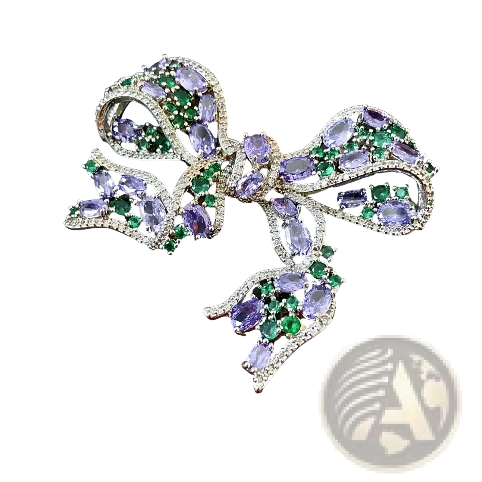 A sparkling silver zircon bow brooch with oval-cut purple and green gemstones luxury French design jewelry