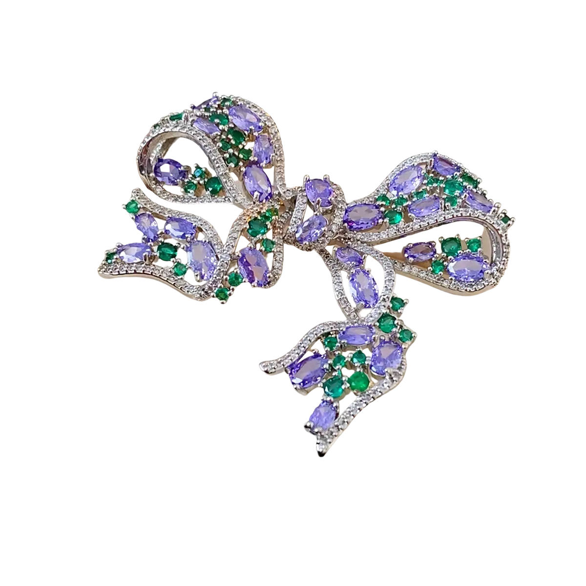 Zircon bow brooch luxury French design featuring a silver bow with oval purple gemstones and green emerald accents