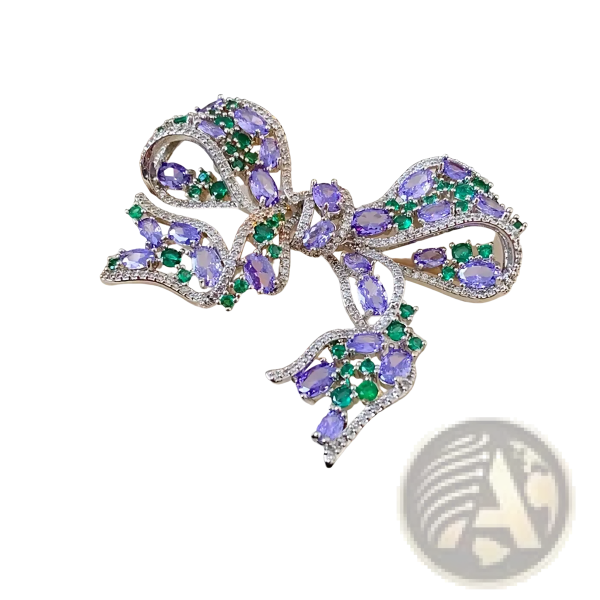 Zircon bow brooch luxury French design featuring a silver bow with oval purple gemstones and green emerald accents