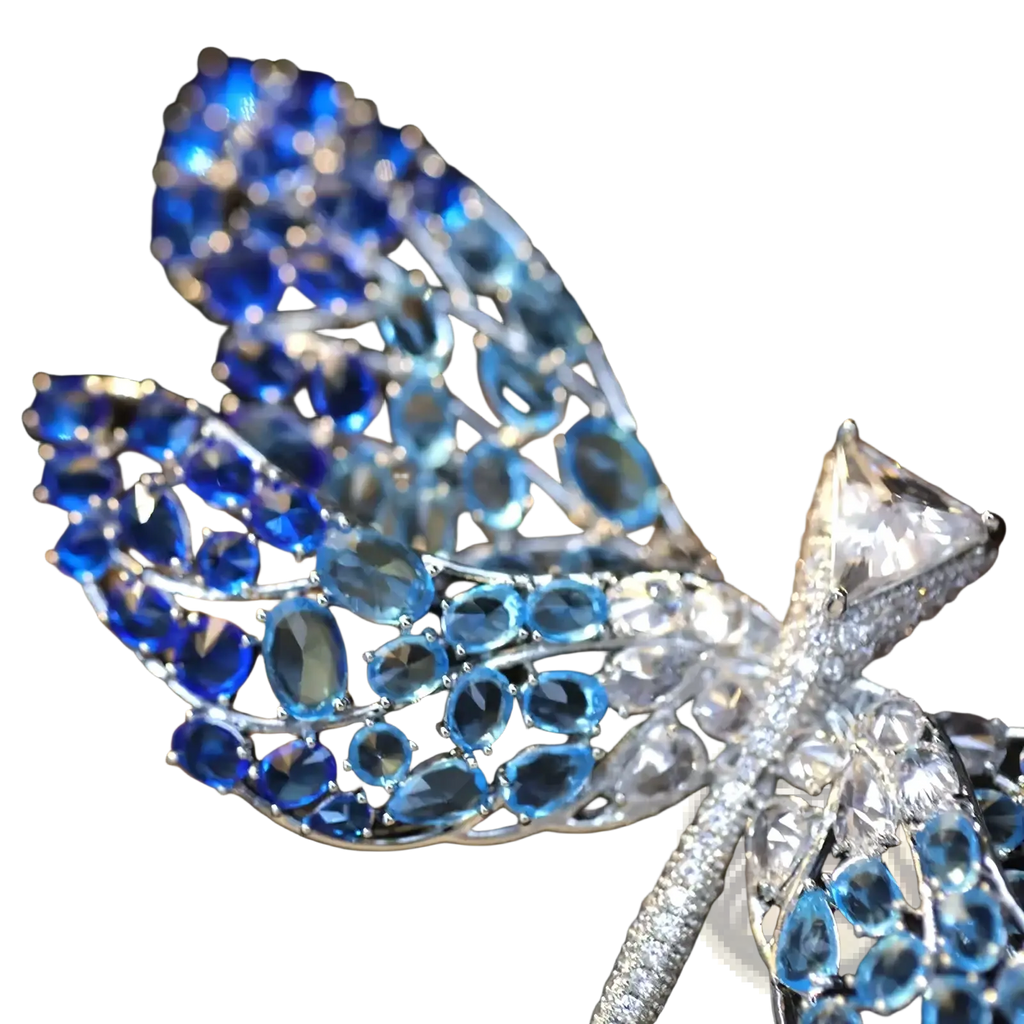 Zircon butterfly brooch featuring a sparkling blue and white dragonfly with oval-cut sapphires and diamonds on silver metal