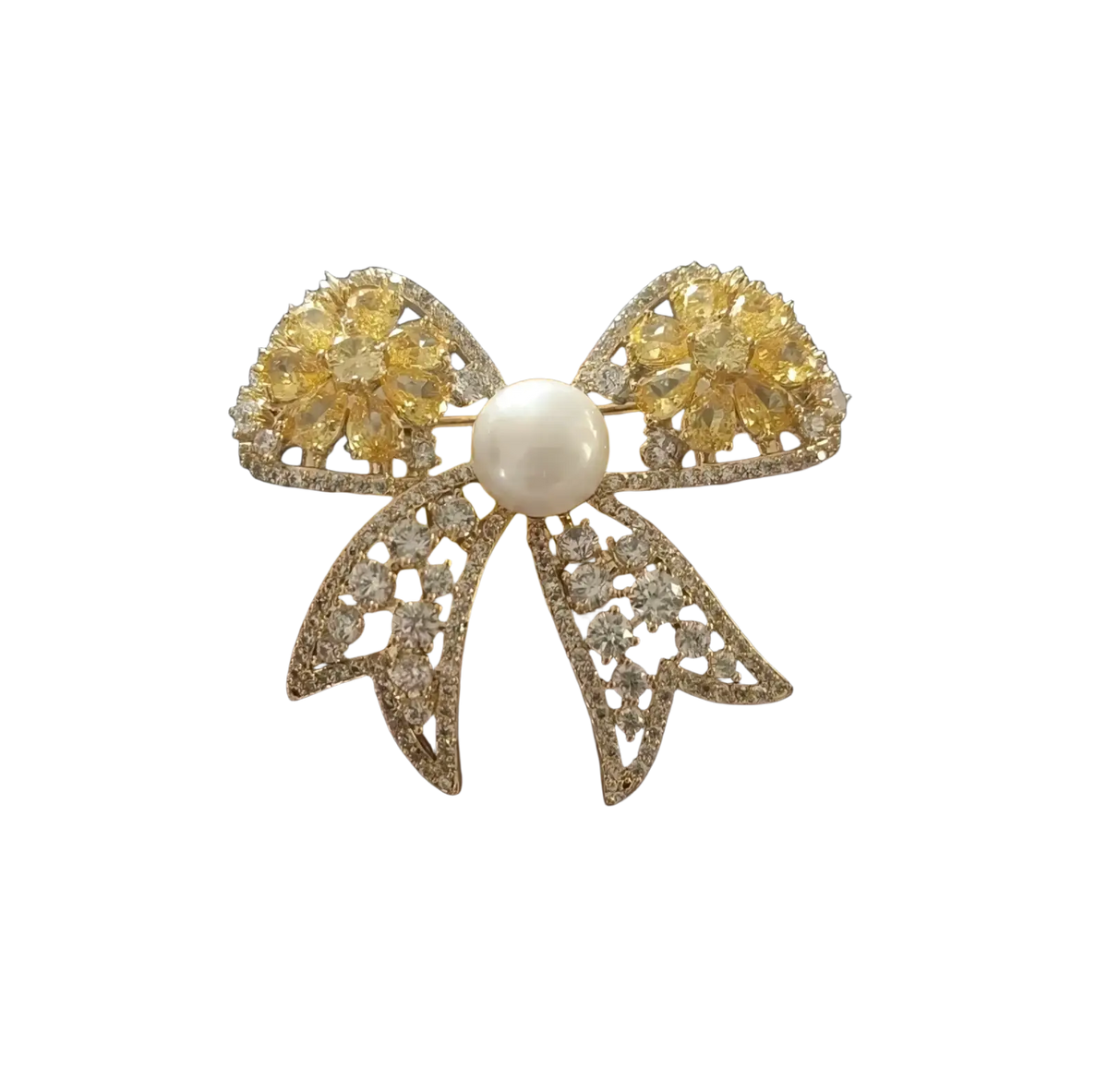 A sparkling gold zircon butterfly brooch adorned with yellow and clear gemstones and a white pearl centerpiece
