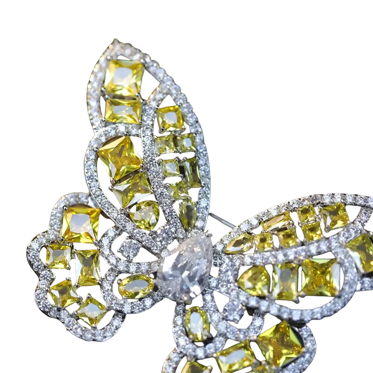 A zircon butterfly brooch with vibrant yellow and clear gemstones set in a silver-toned metal frame