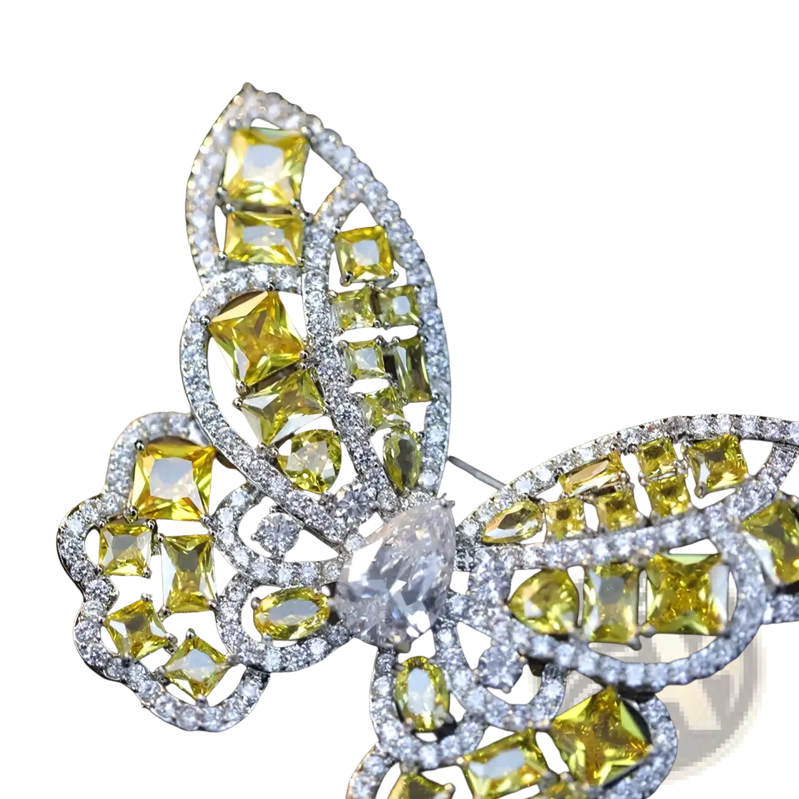 A zircon butterfly brooch with vibrant yellow and clear gemstones set in a silver-toned metal frame