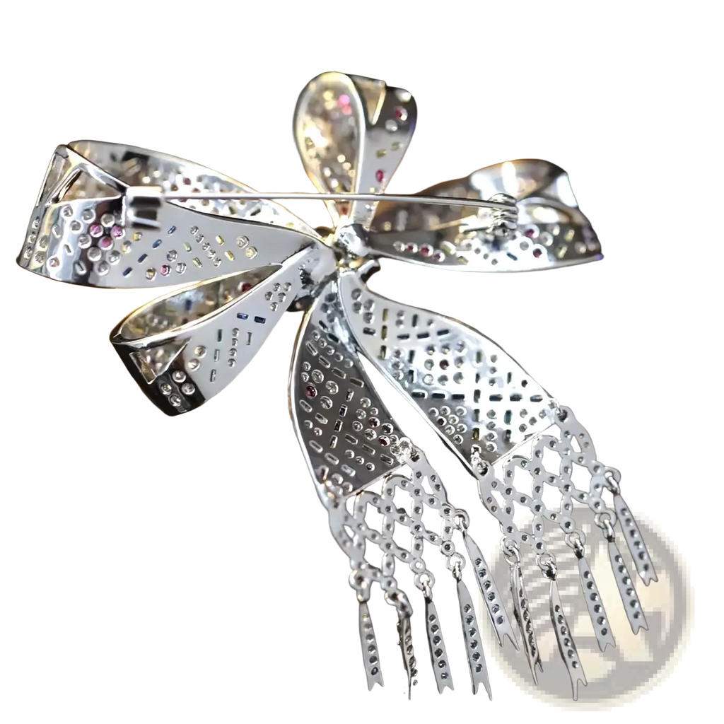 A sparkling silver zircon butterfly brooch with intricate cut-out patterns and pink blue clear gemstones