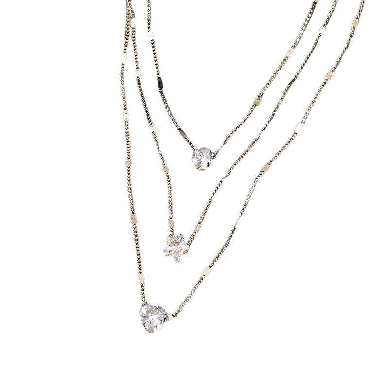 A delicate gold-toned zircon layered pendant necklace for women with three chains and star and heart crystal charms