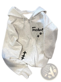 A soft heather gray fleece zip-up hoodie for women featuring a black paw print and medw graphic design by Zoki