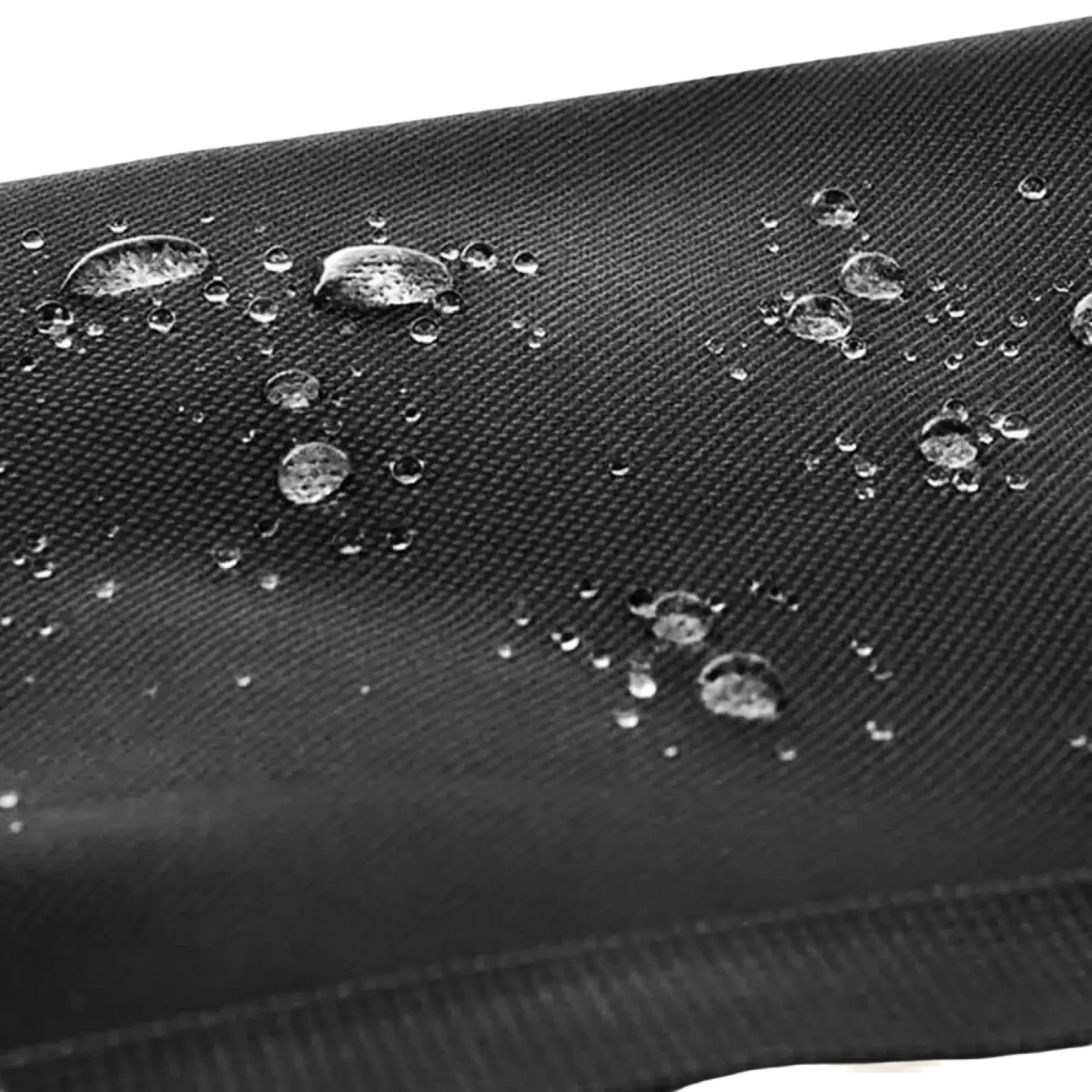 Black textured fabric with water droplets beading on the surface of the Ztz 50l waterproof dual bicycle pannier bag
